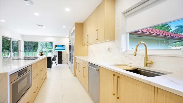 a kitchen with stainless steel appliances a sink and cabinets
