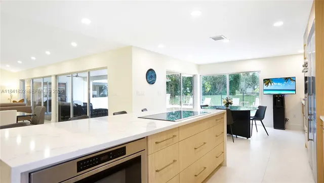 a dining room with furniture and a floor to ceiling window