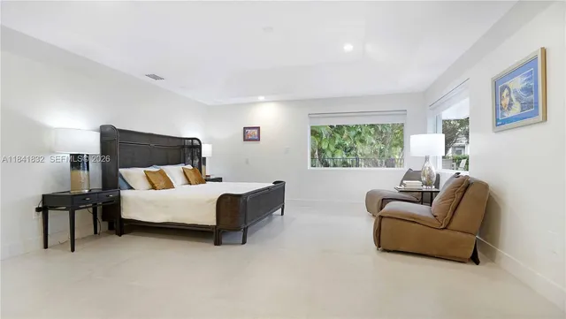 a view of house with swimming pool and sitting area