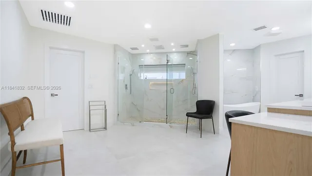 a view of a swimming pool with a table and chairs under an umbrella