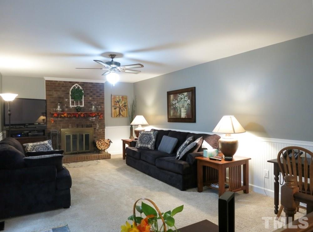 4516 Wingate Drive Raleigh, NC 27609 - Photo 11 of 25 a living room with furniture a lamp and a chandelier