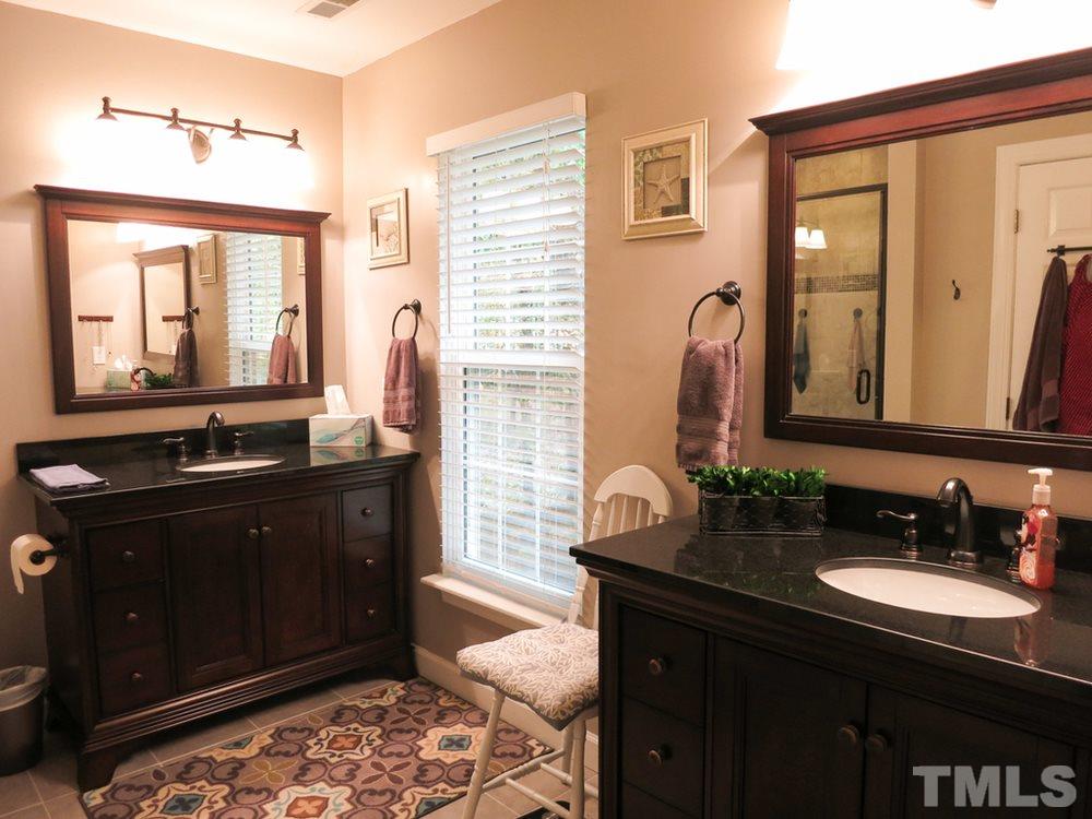 4516 Wingate Drive Raleigh, NC 27609 - Photo 16 of 25 a bathroom with a sink vanity and a mirror