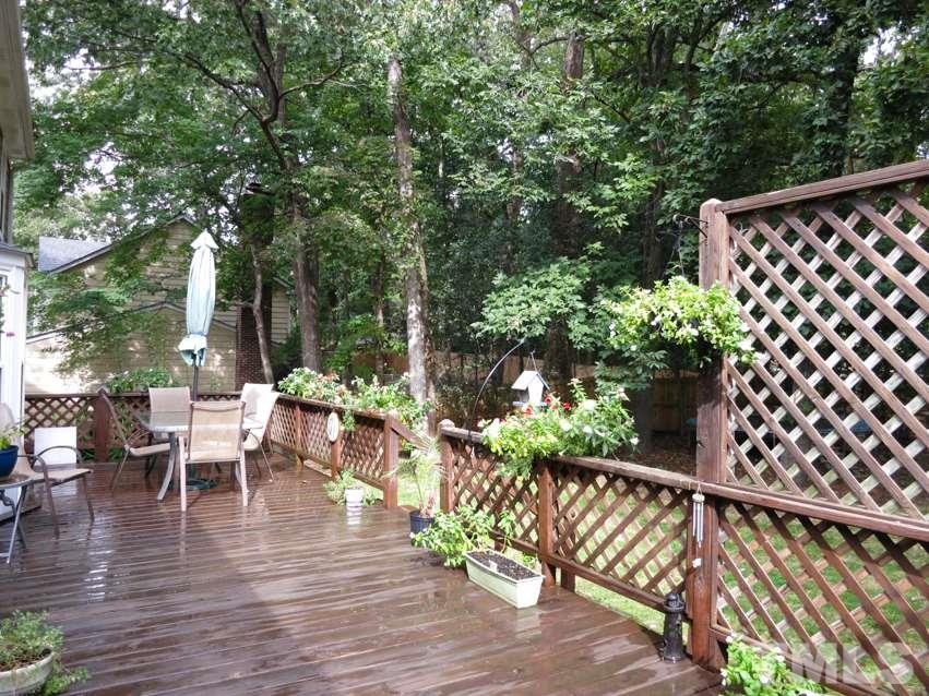 4516 Wingate Drive Raleigh, NC 27609 - Photo 22 of 25 a view of a patio with table and chairs with wooden floor and fence