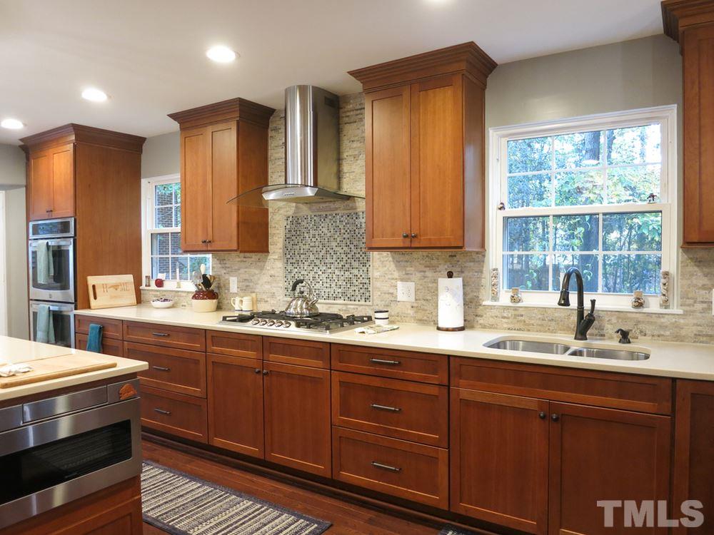 4516 Wingate Drive Raleigh, NC 27609 - Photo 8 of 25 a kitchen with stainless steel appliances granite countertop a sink a stove cabinets and wooden floor
