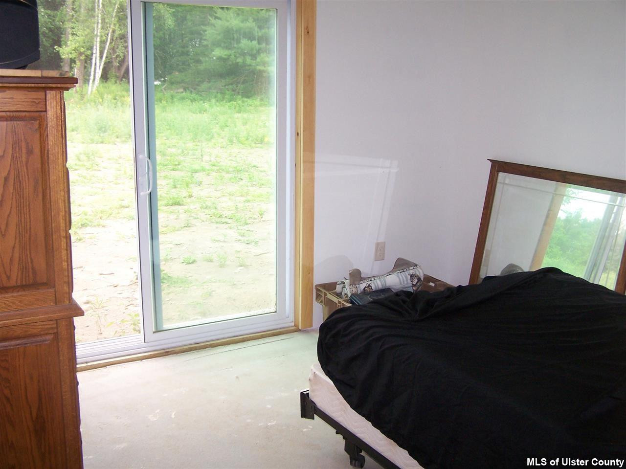 60 Piazza Road Kerhonkson, NY 12446 - Photo 7 of 14 a bed sitting in a bedroom next to a window