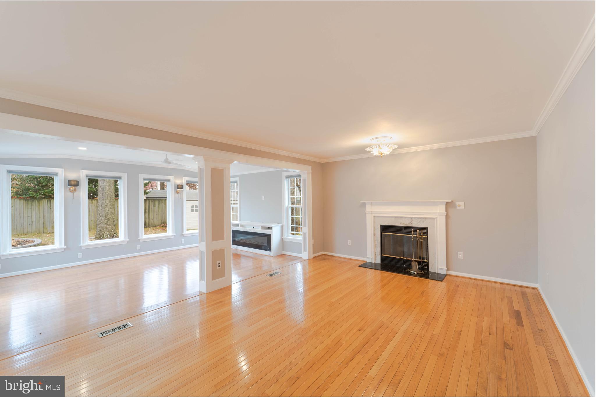 9407 Copernicus Drive Lanham, MD 20706 - Photo 18 of 48 a view of an empty room with a fireplace and a window