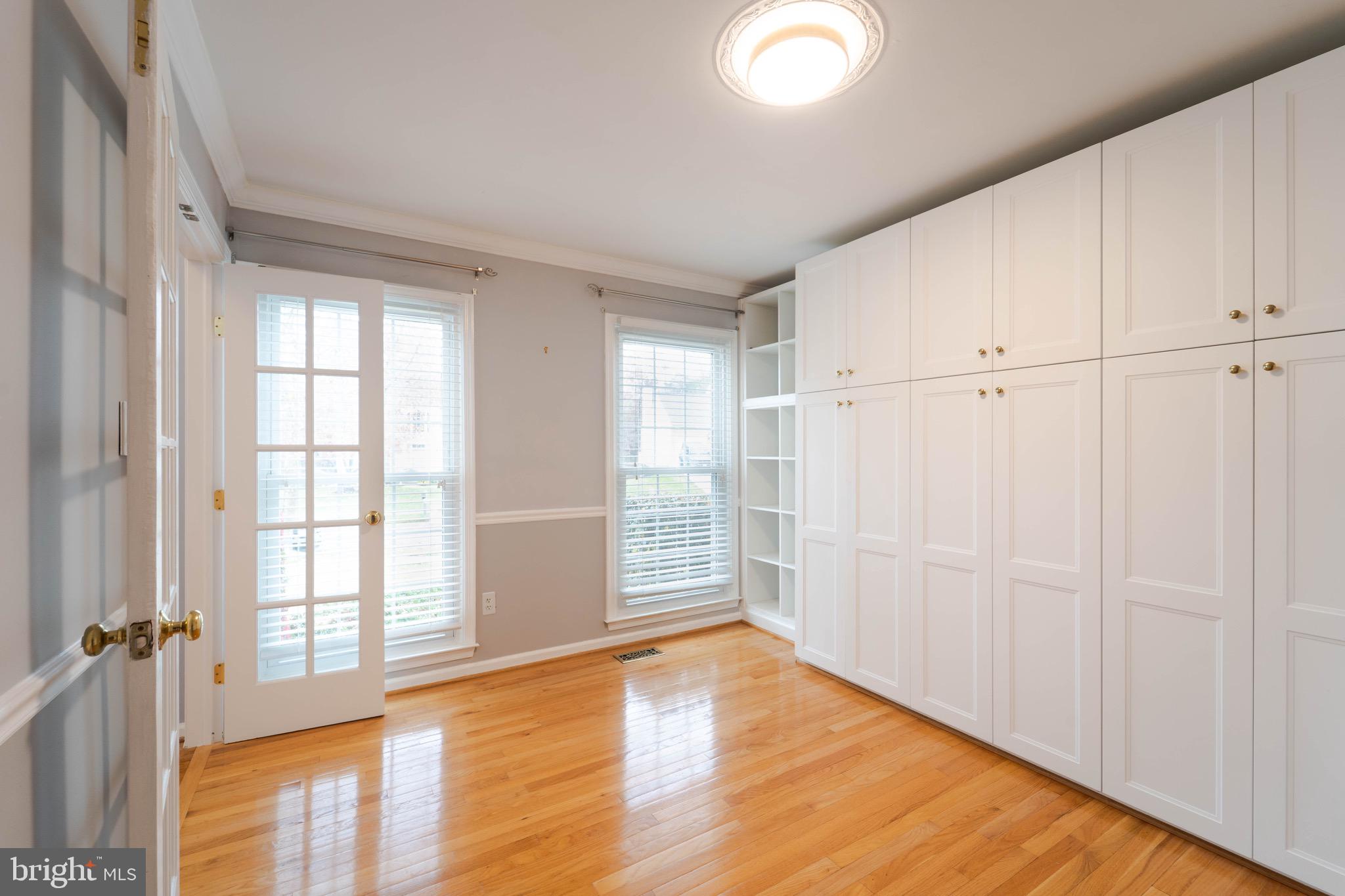 9407 Copernicus Drive Lanham, MD 20706 - Photo 24 of 48 a view of an empty room with glass door and wooden floor