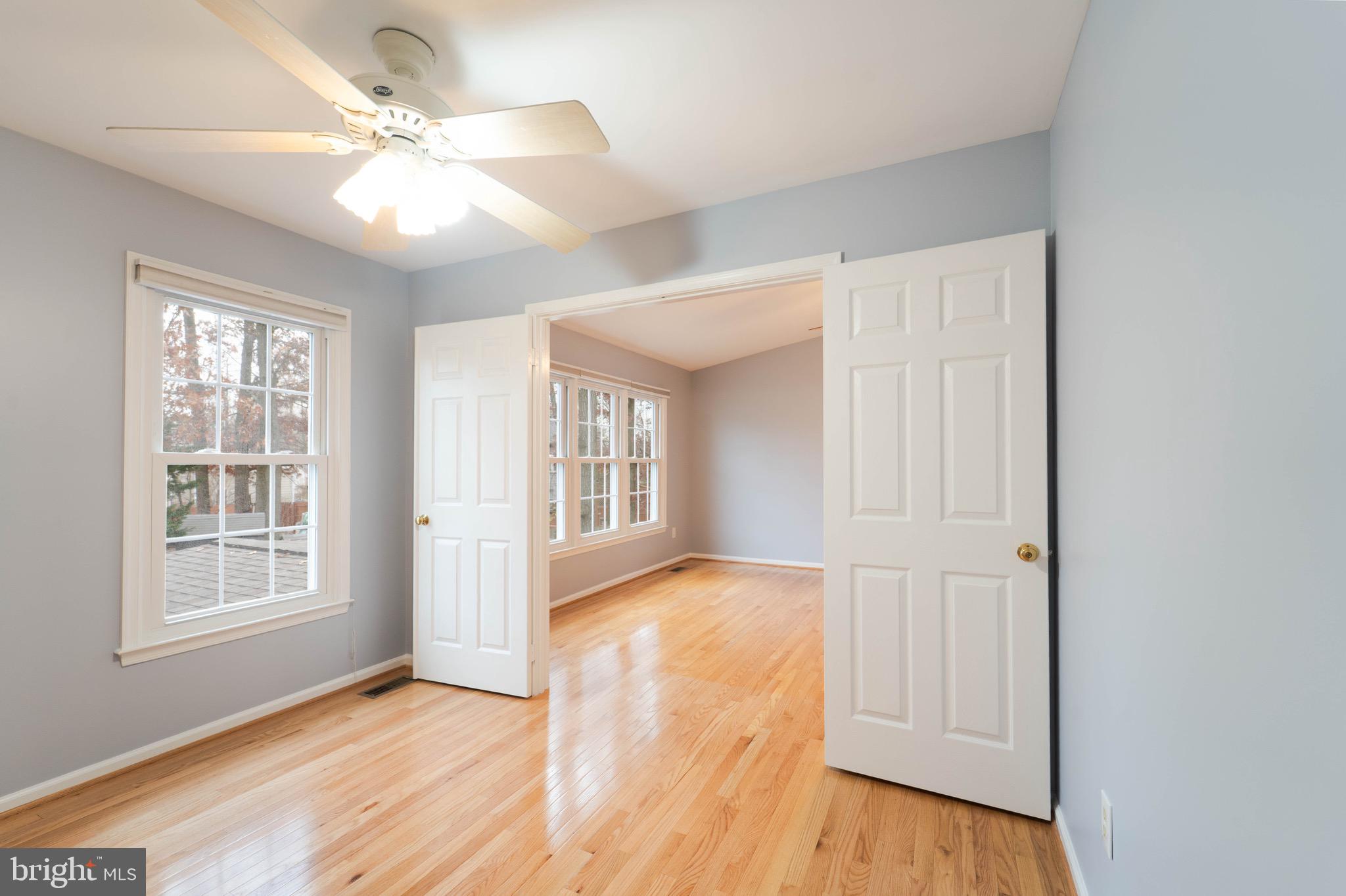 9407 Copernicus Drive Lanham, MD 20706 - Photo 28 of 48 an empty room with wooden floor fan and windows
