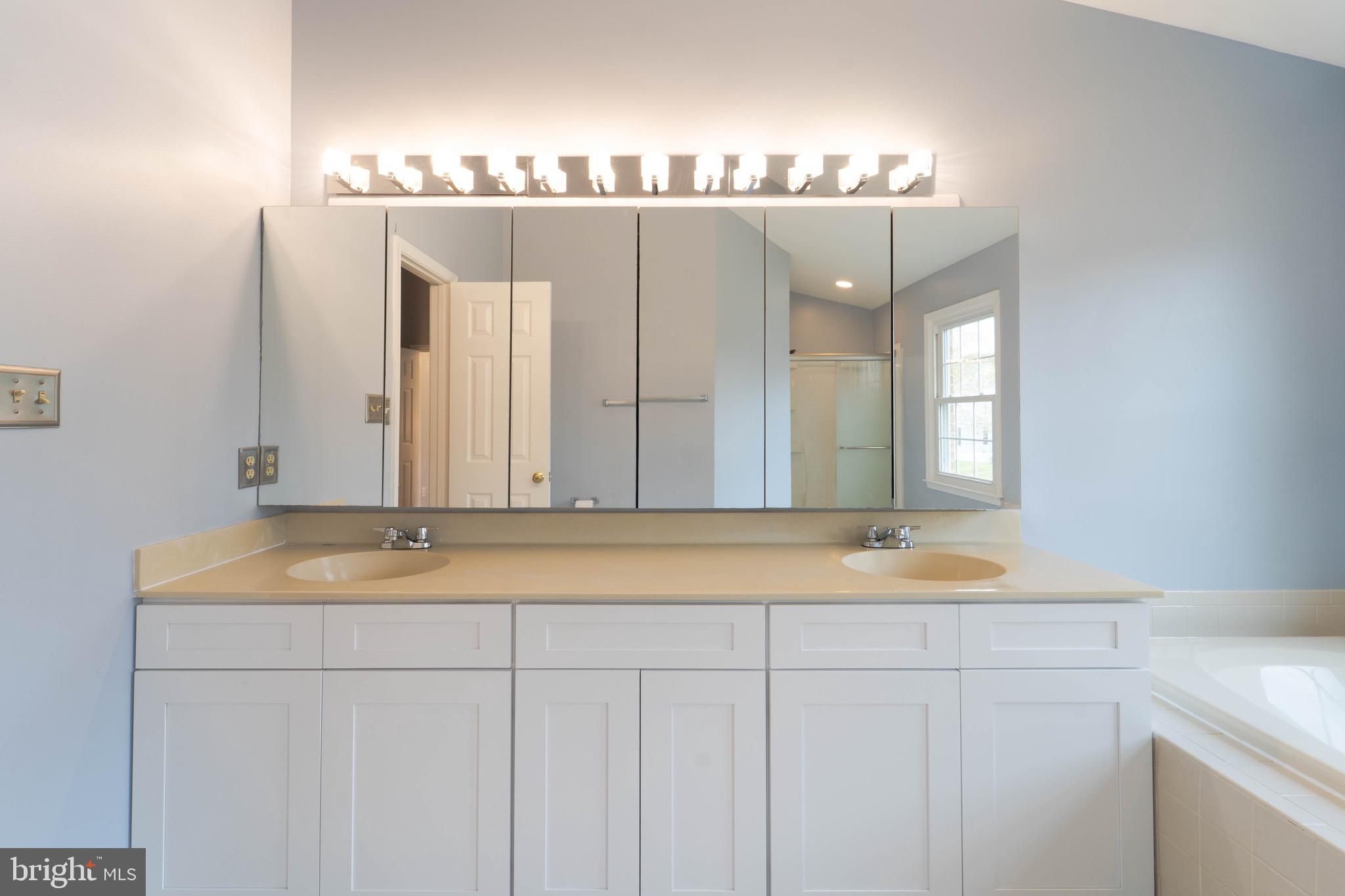 9407 Copernicus Drive Lanham, MD 20706 - Photo 31 of 48 a bathroom with a sink and a mirror