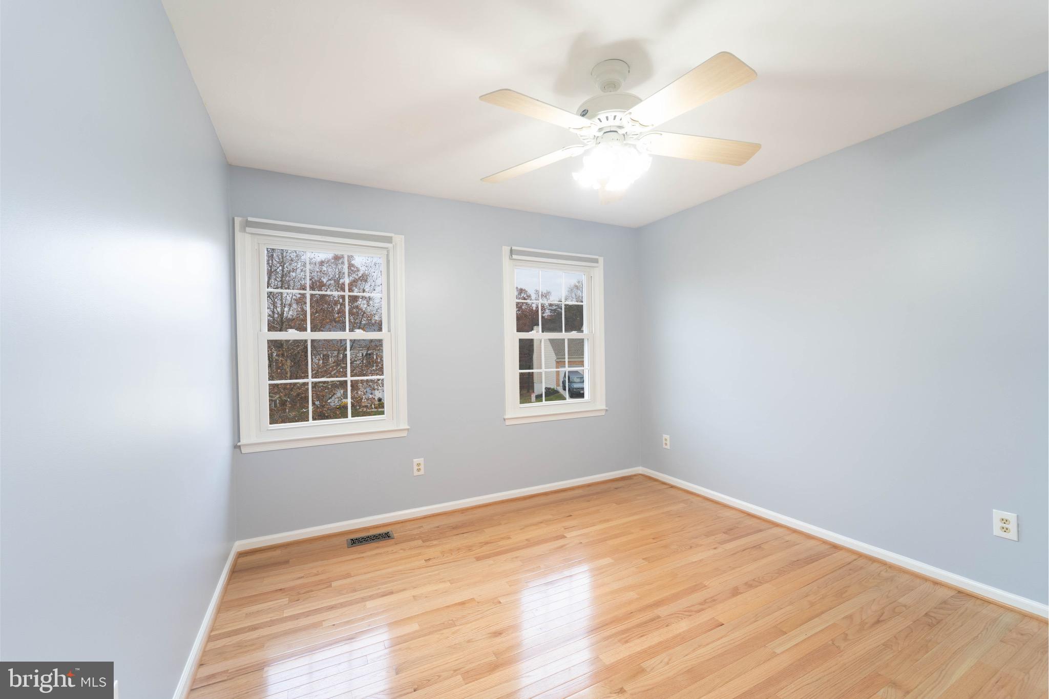 9407 Copernicus Drive Lanham, MD 20706 - Photo 35 of 48 a view of an empty room with wooden floor and a window