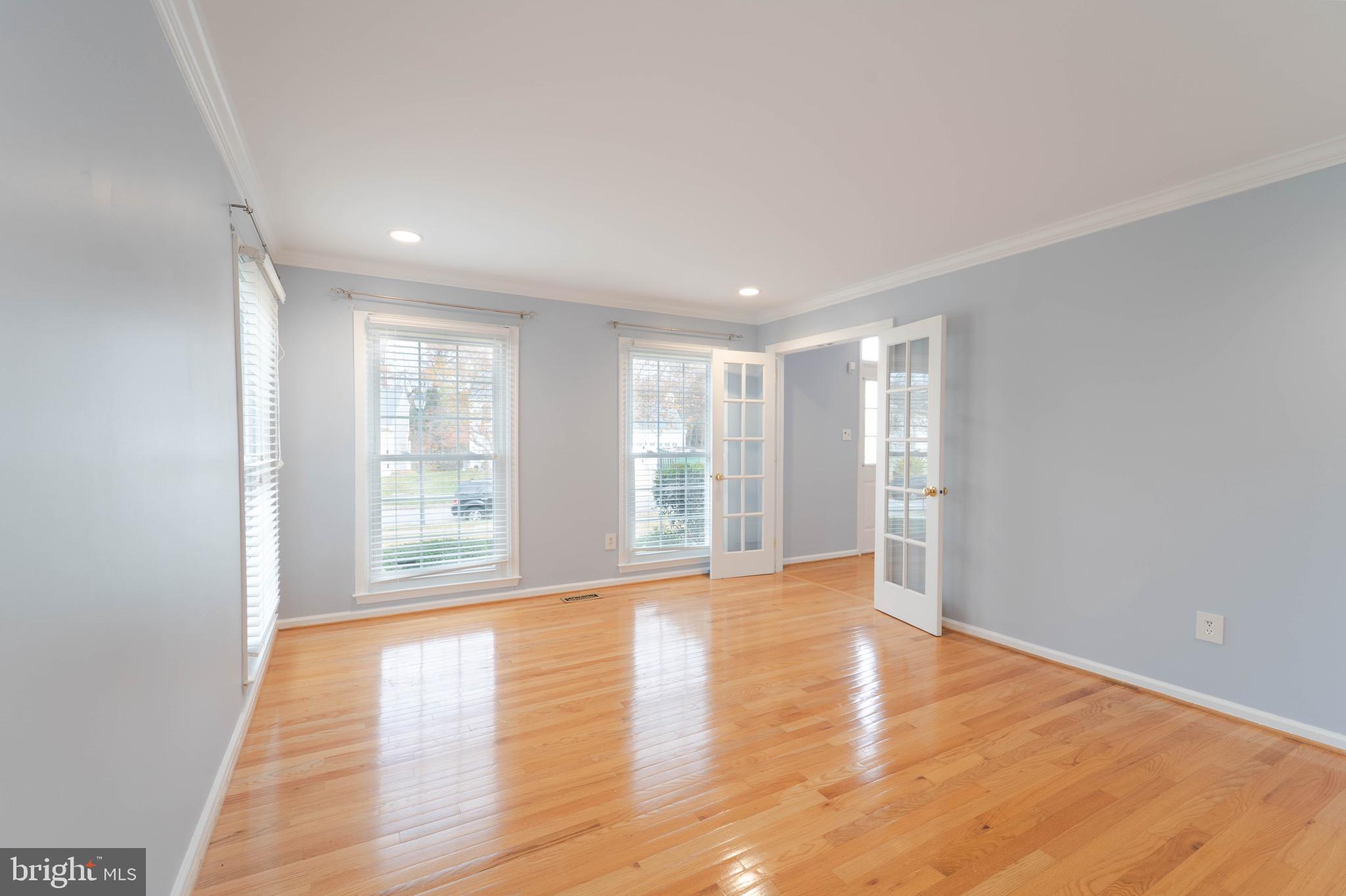 9407 Copernicus Drive Lanham, MD 20706 - Photo 5 of 48 a view of an empty room with wooden floor and a window