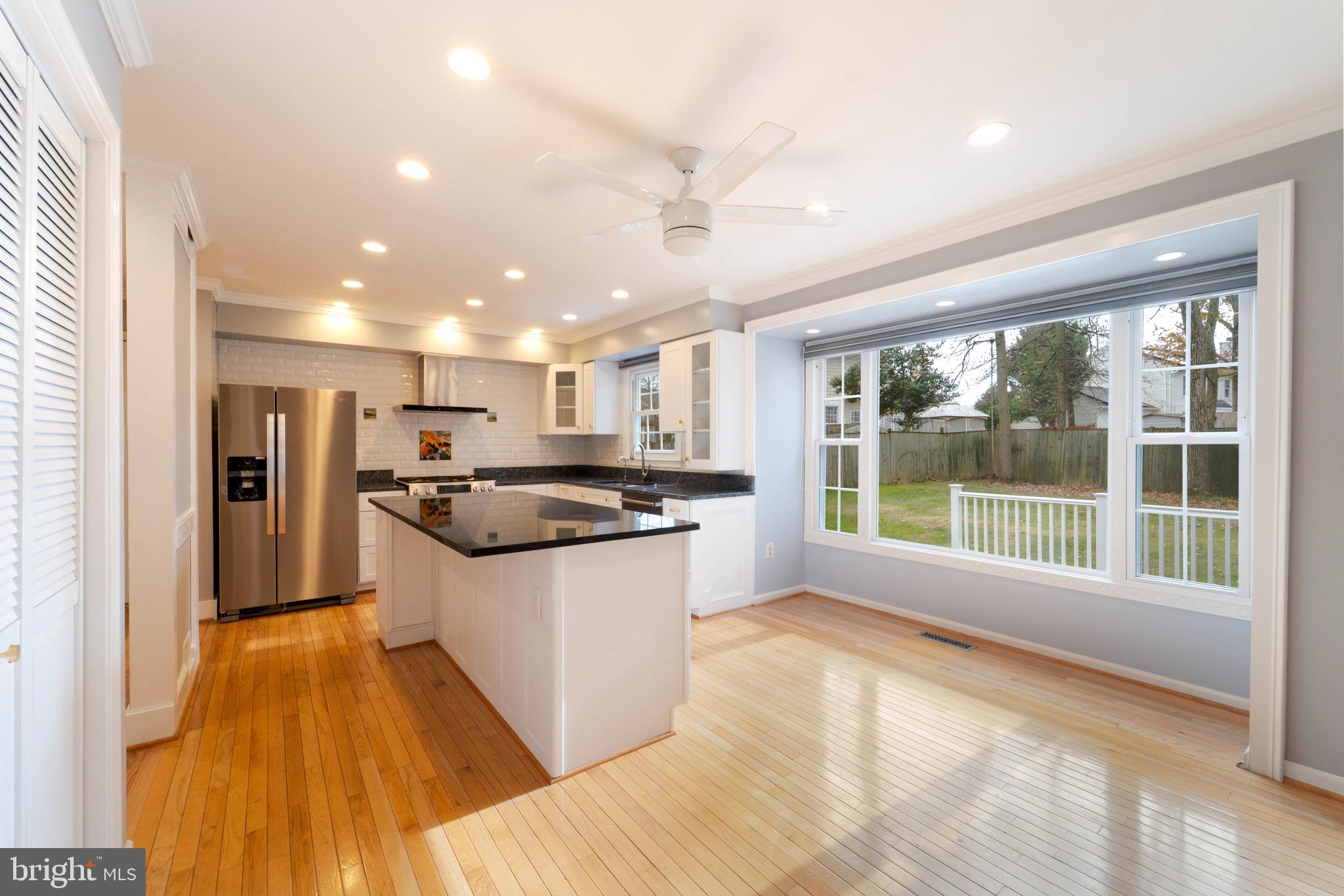 9407 Copernicus Drive Lanham, MD 20706 - Photo 6 of 48 a kitchen with stainless steel appliances granite countertop a sink and a stove