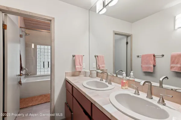 a bathroom with a sink double vanity and a mirror