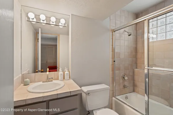 a bathroom with a toilet a sink and a mirror