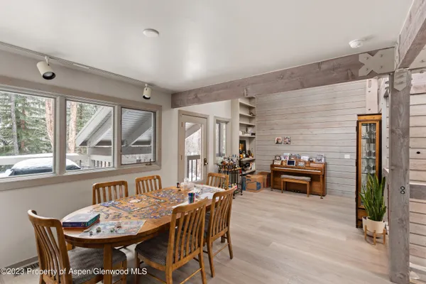 a dining room with furniture window and wooden floor