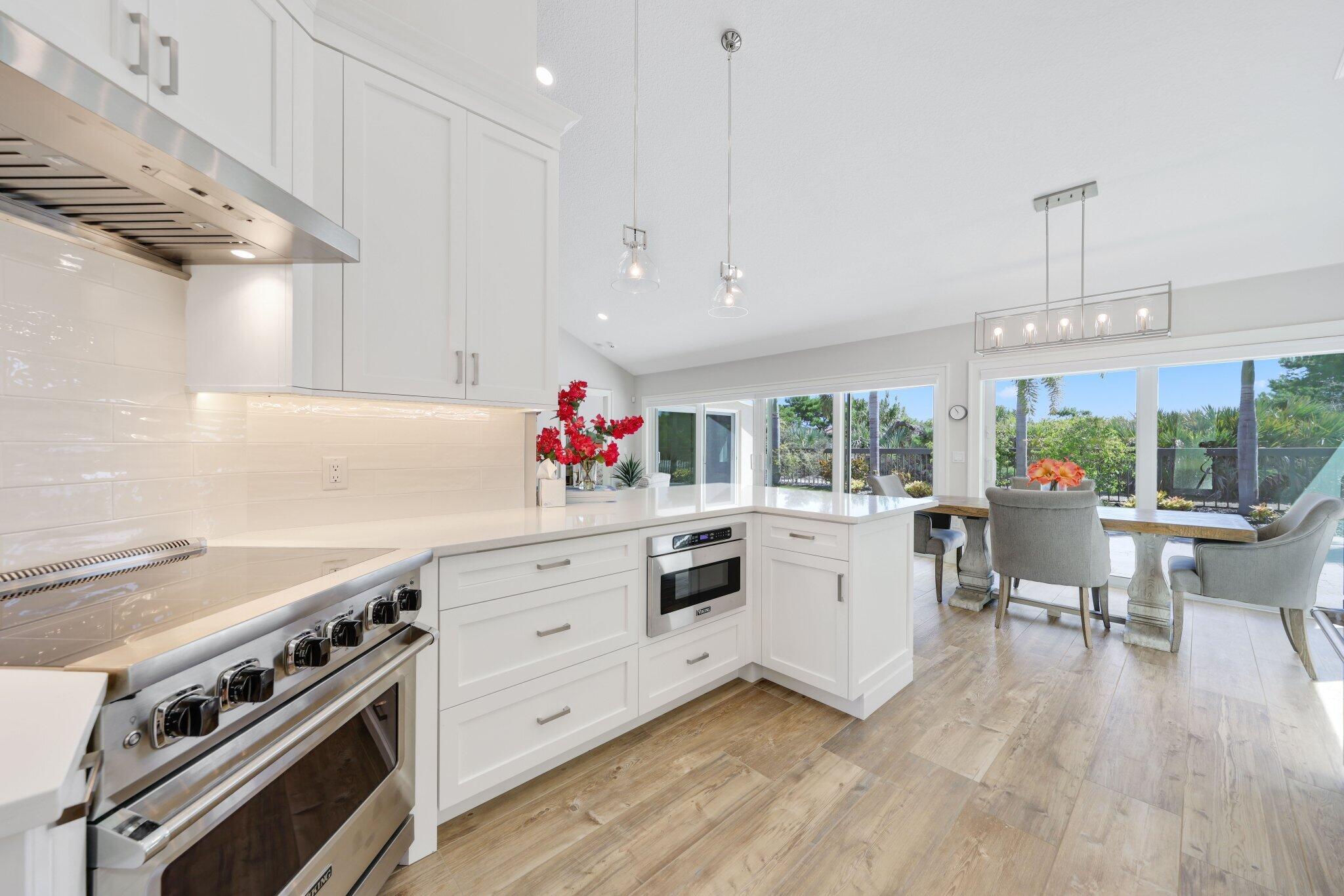215 Ridge Road Jupiter, FL 33477 - Photo 13 of 43 a kitchen that has a lot of cabinets in it