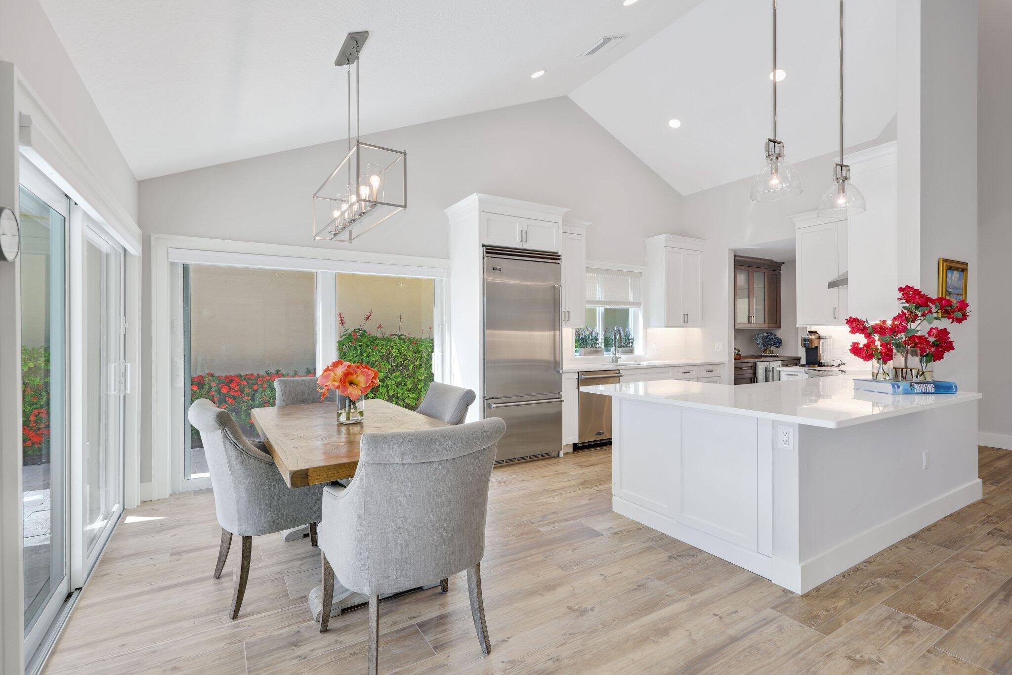 215 Ridge Road Jupiter, FL 33477 - Photo 16 of 43 a view of a dining room with furniture wooden floor and chandelier