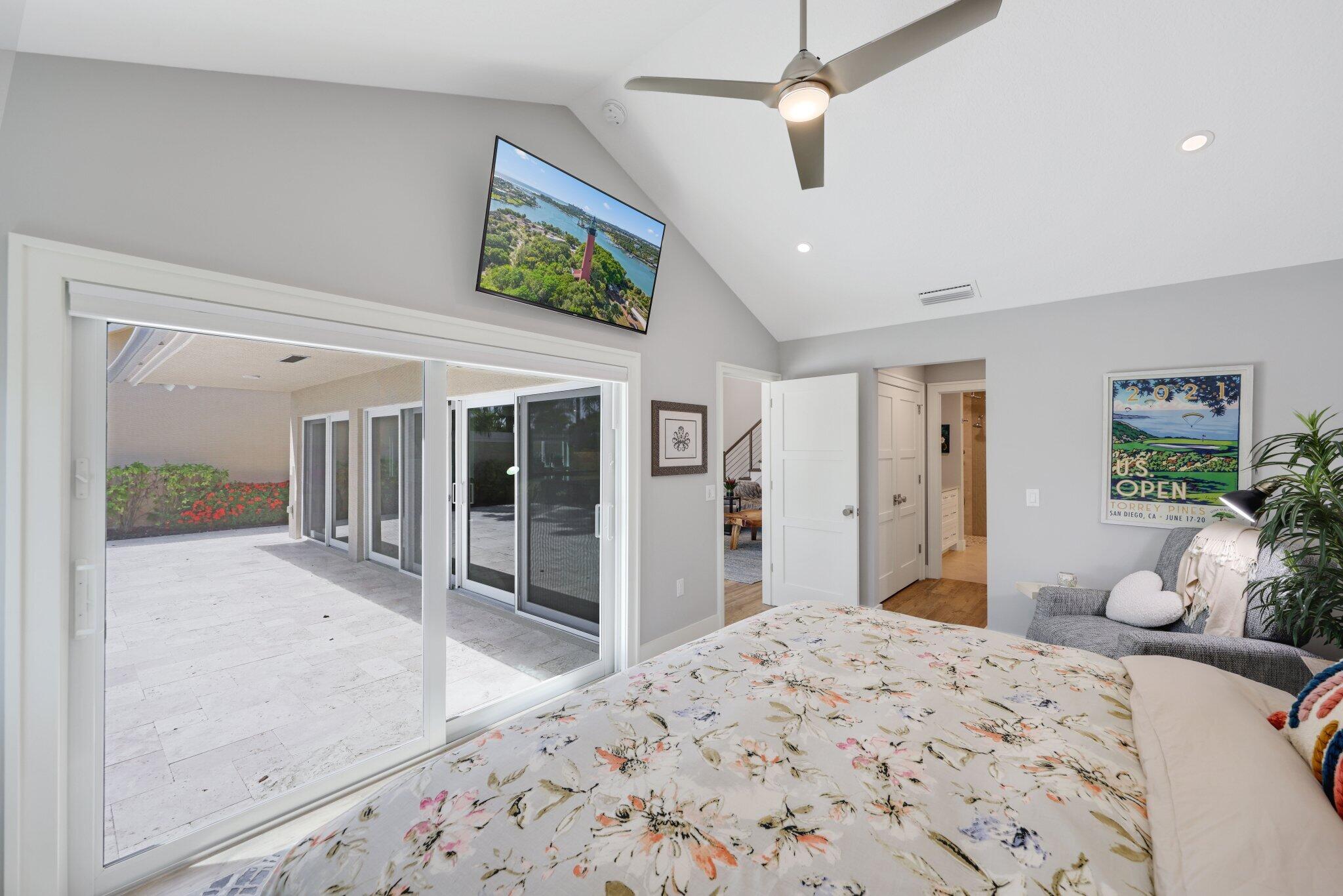 215 Ridge Road Jupiter, FL 33477 - Photo 19 of 43 a bedroom with a bed chandelier and a window