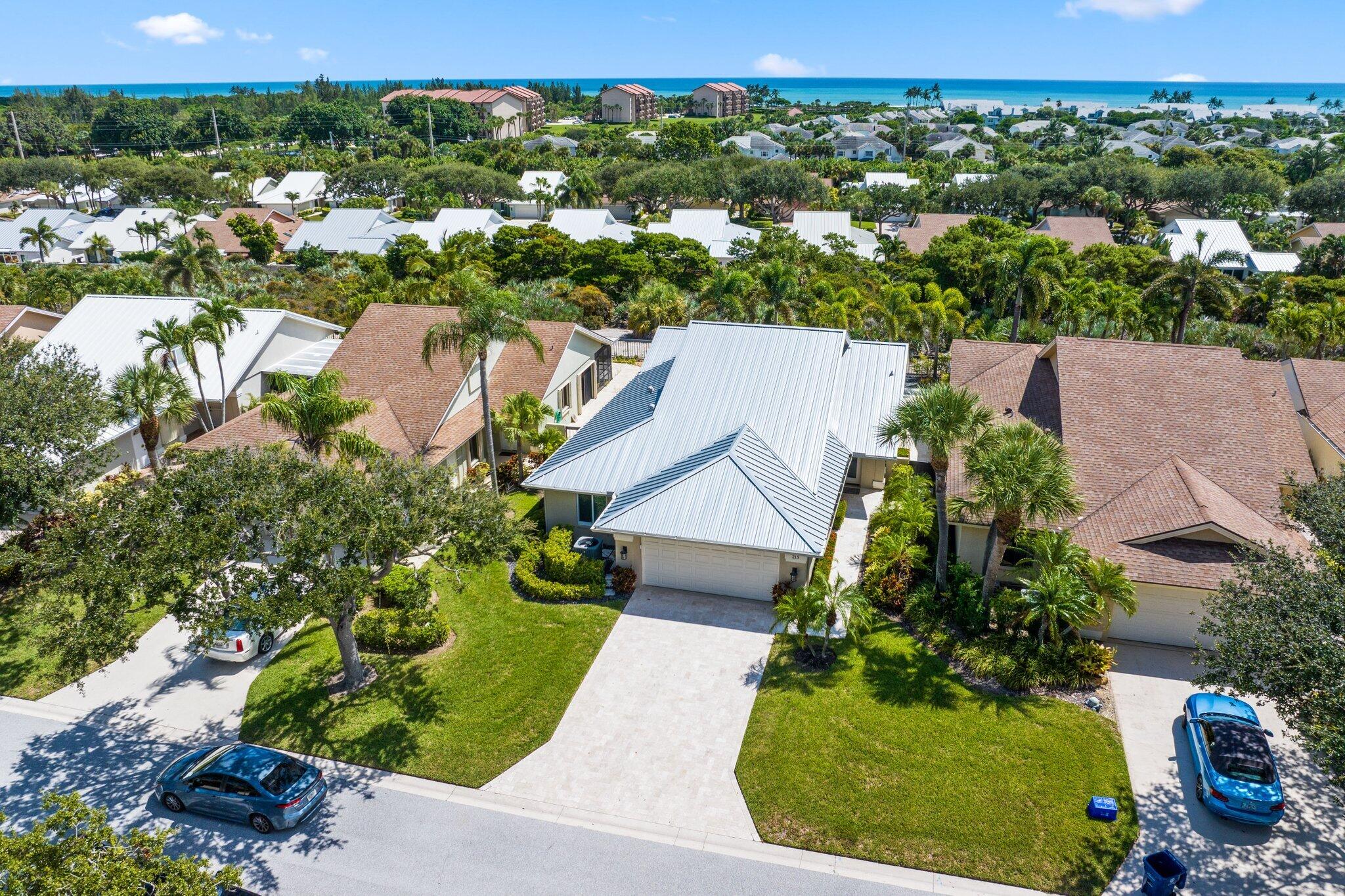 215 Ridge Road Jupiter, FL 33477 - Photo 2 of 43 an aerial view of a house with a yard and lake view