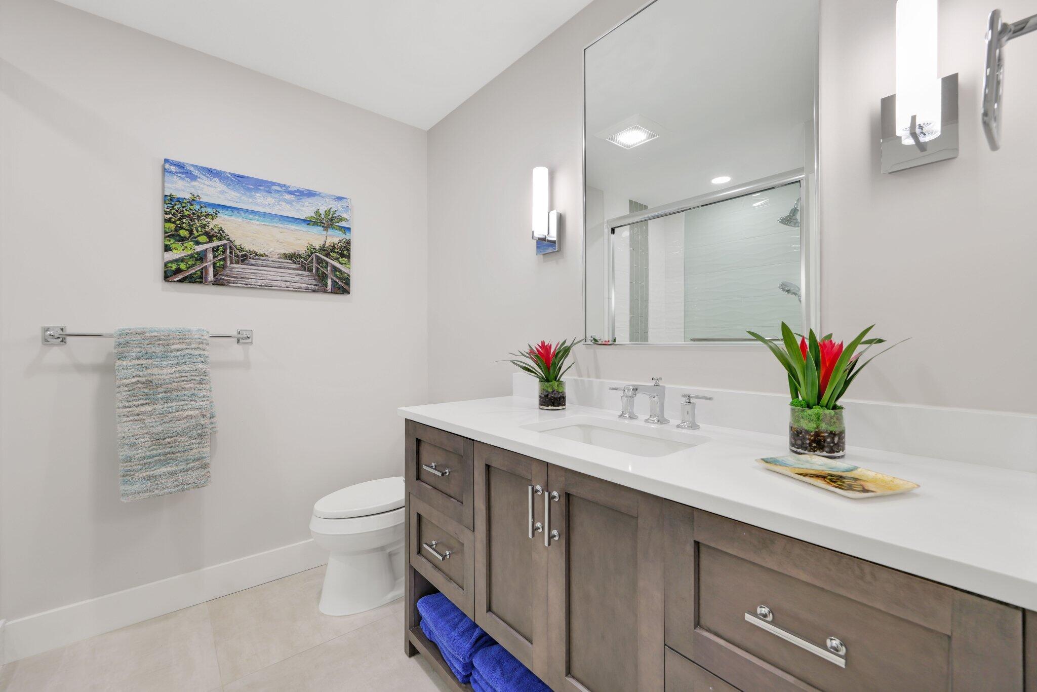 215 Ridge Road Jupiter, FL 33477 - Photo 25 of 43 a bathroom with a granite countertop sink a toilet a large mirror and shower