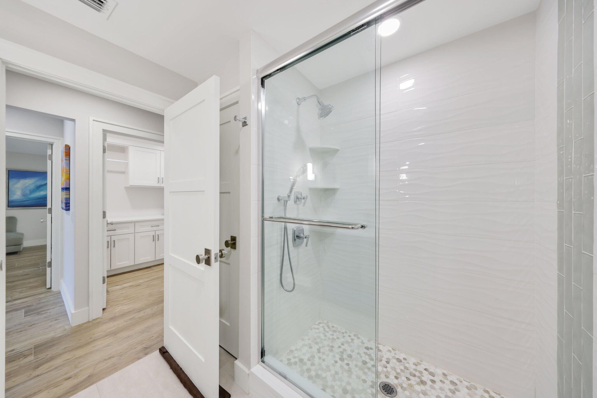 215 Ridge Road Jupiter, FL 33477 - Photo 26 of 43 a bathroom with a glass shower door