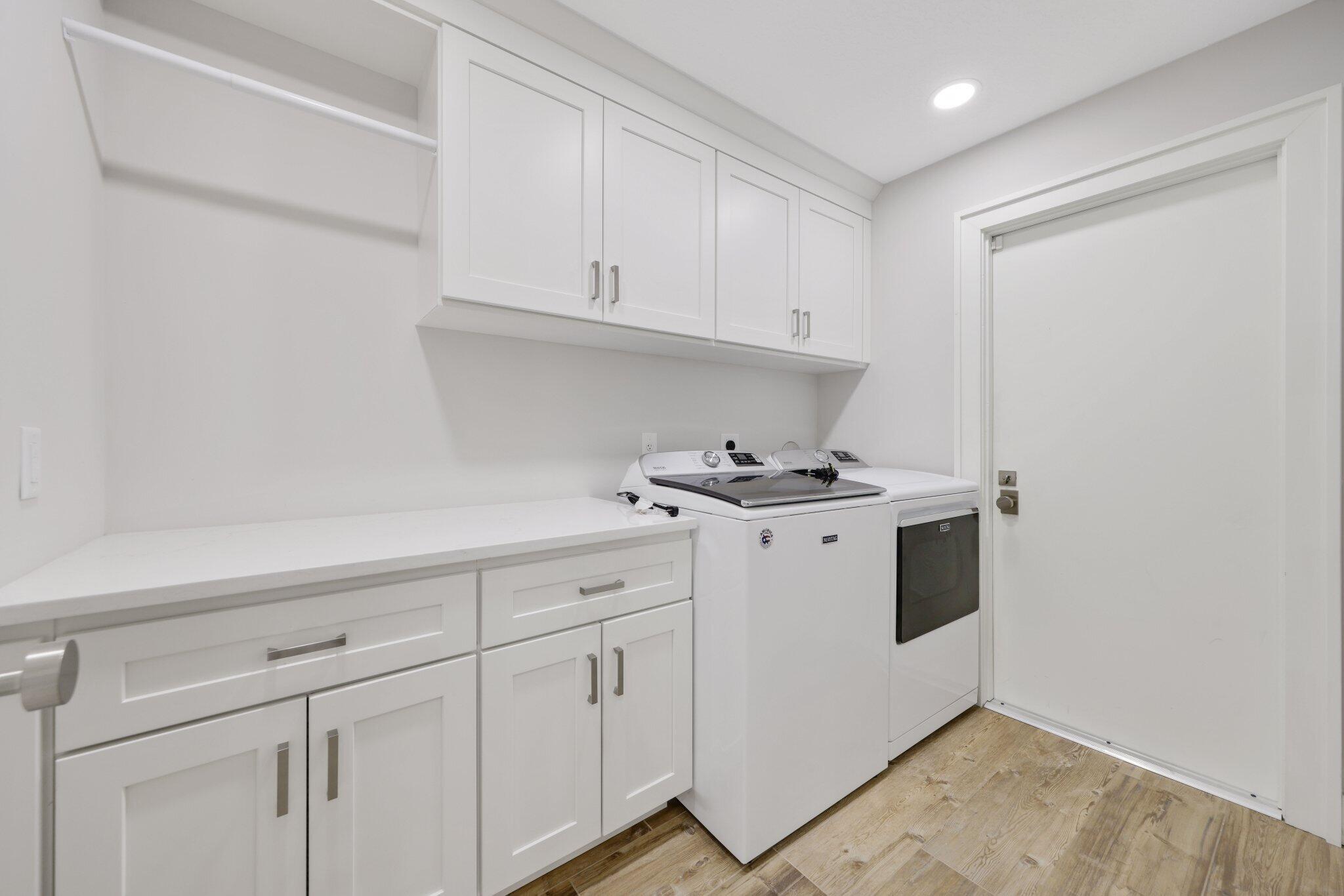 215 Ridge Road Jupiter, FL 33477 - Photo 27 of 43 a kitchen with white cabinets and white appliances