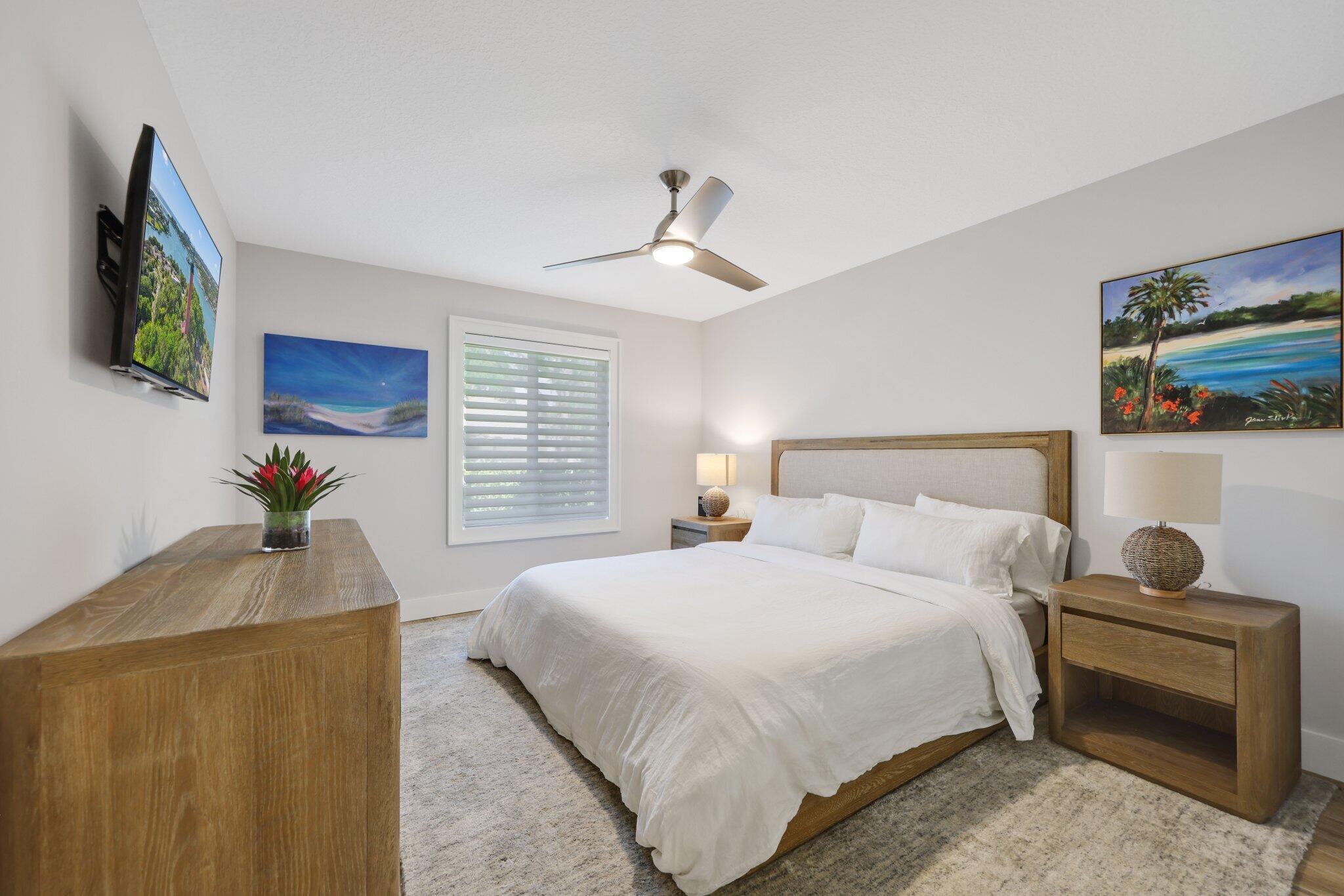 215 Ridge Road Jupiter, FL 33477 - Photo 28 of 43 a bedroom with a bed and a painting on the wall