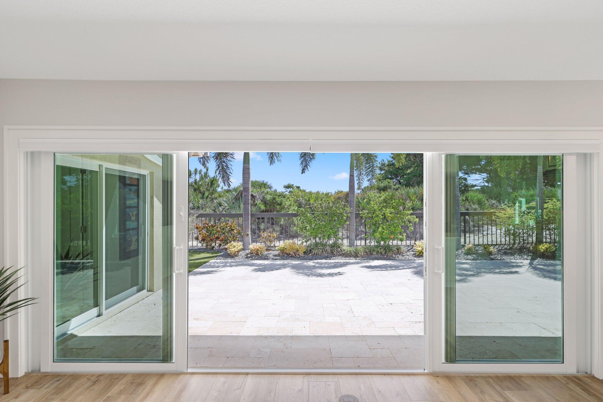215 Ridge Road Jupiter, FL 33477 - Photo 34 of 43 a living room with a floor to ceiling window and pool