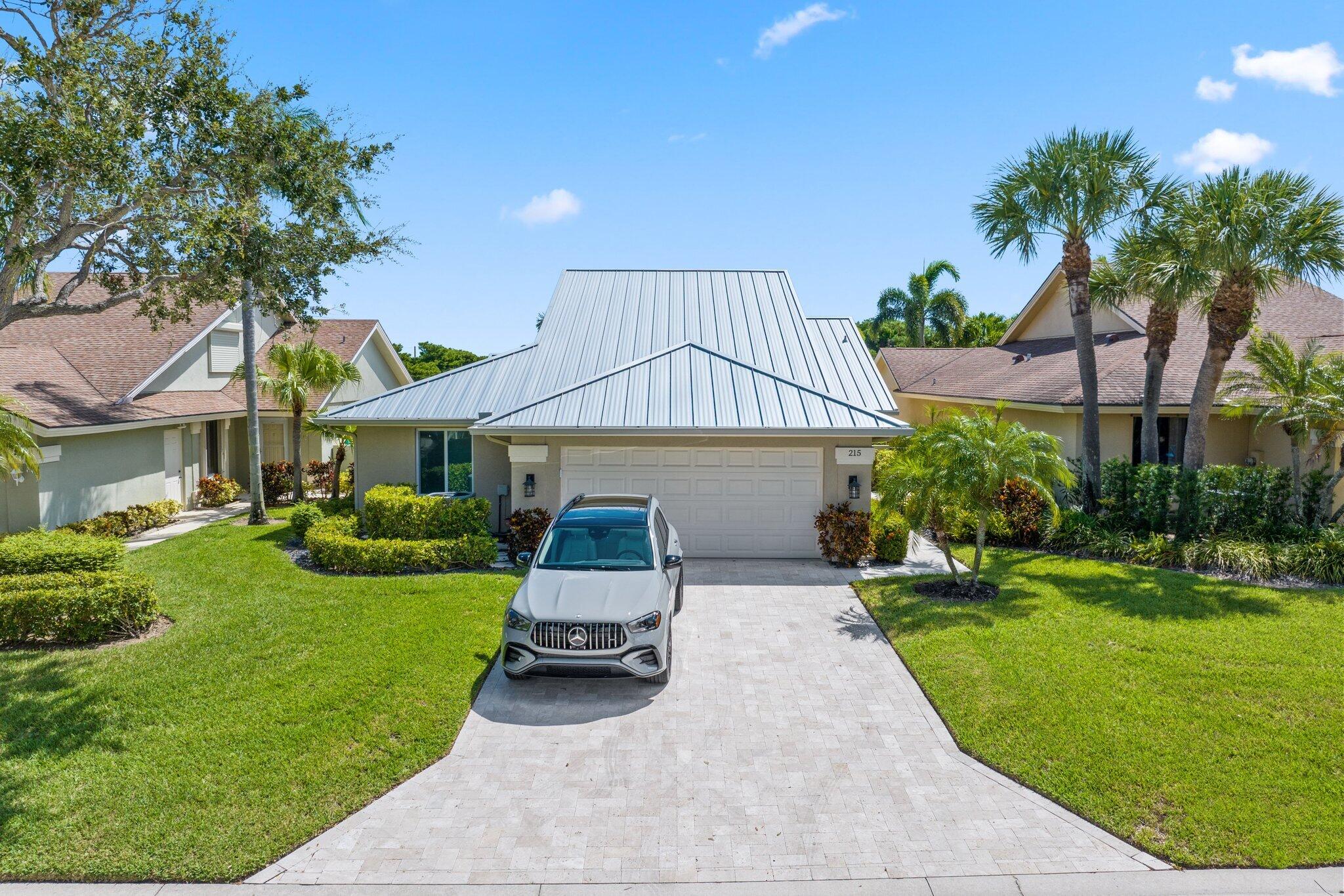 215 Ridge Road Jupiter, FL 33477 - Photo 4 of 43 a view of a house with a yard and sitting area