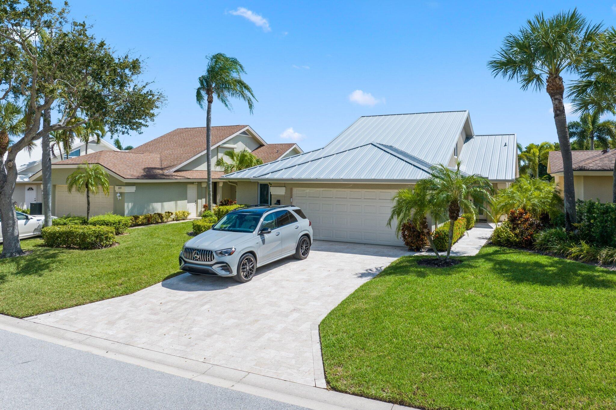215 Ridge Road Jupiter, FL 33477 - Photo 5 of 43 a front view of a house with garden