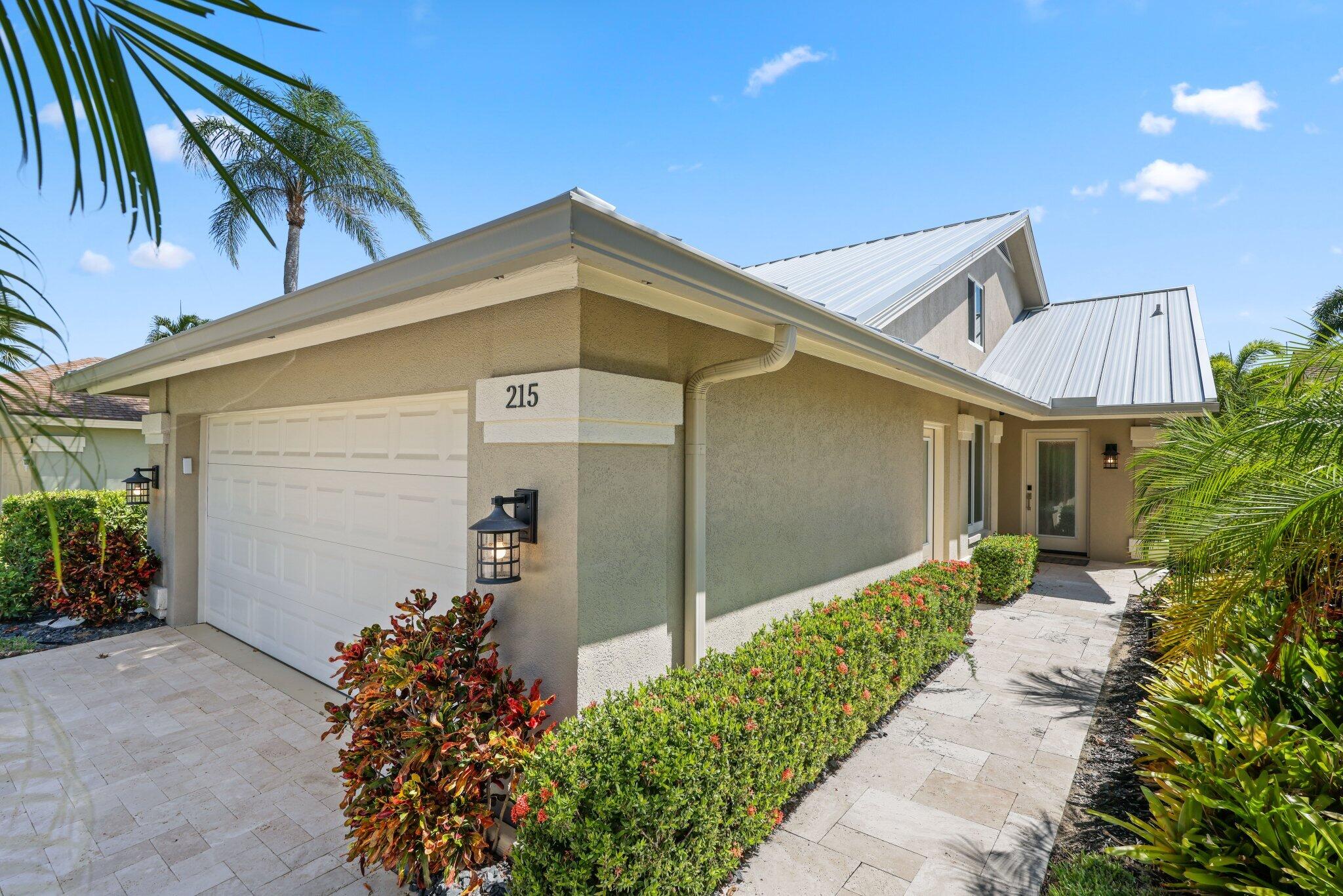 215 Ridge Road Jupiter, FL 33477 - Photo 7 of 43 a front view of a house with a yard