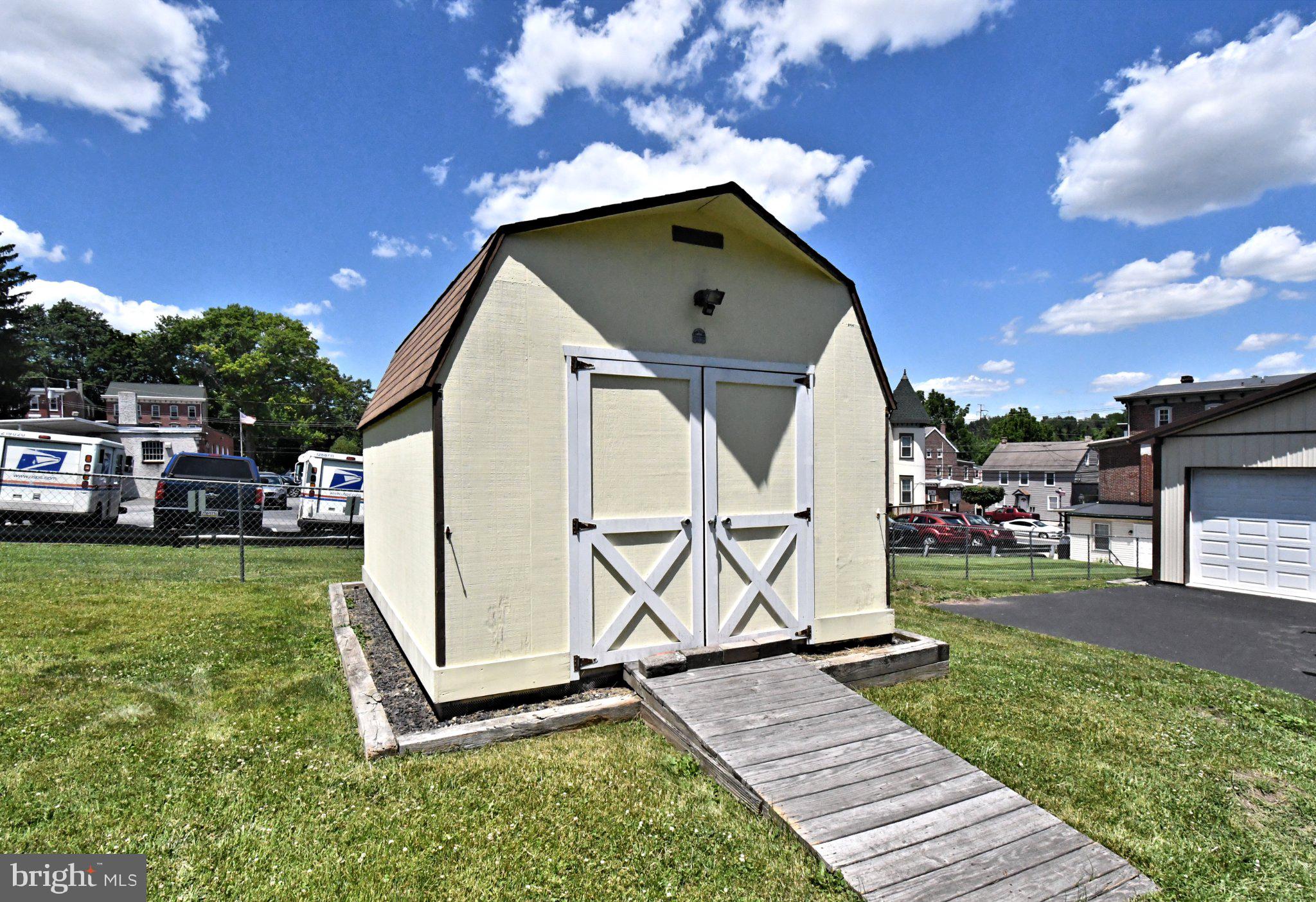 64 North Main Street Spring City, PA 19475 - Photo 26 of 26 Charming shed under a bright sky.