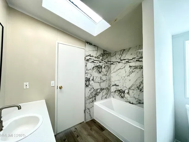 a bathroom with a bathtub and shower