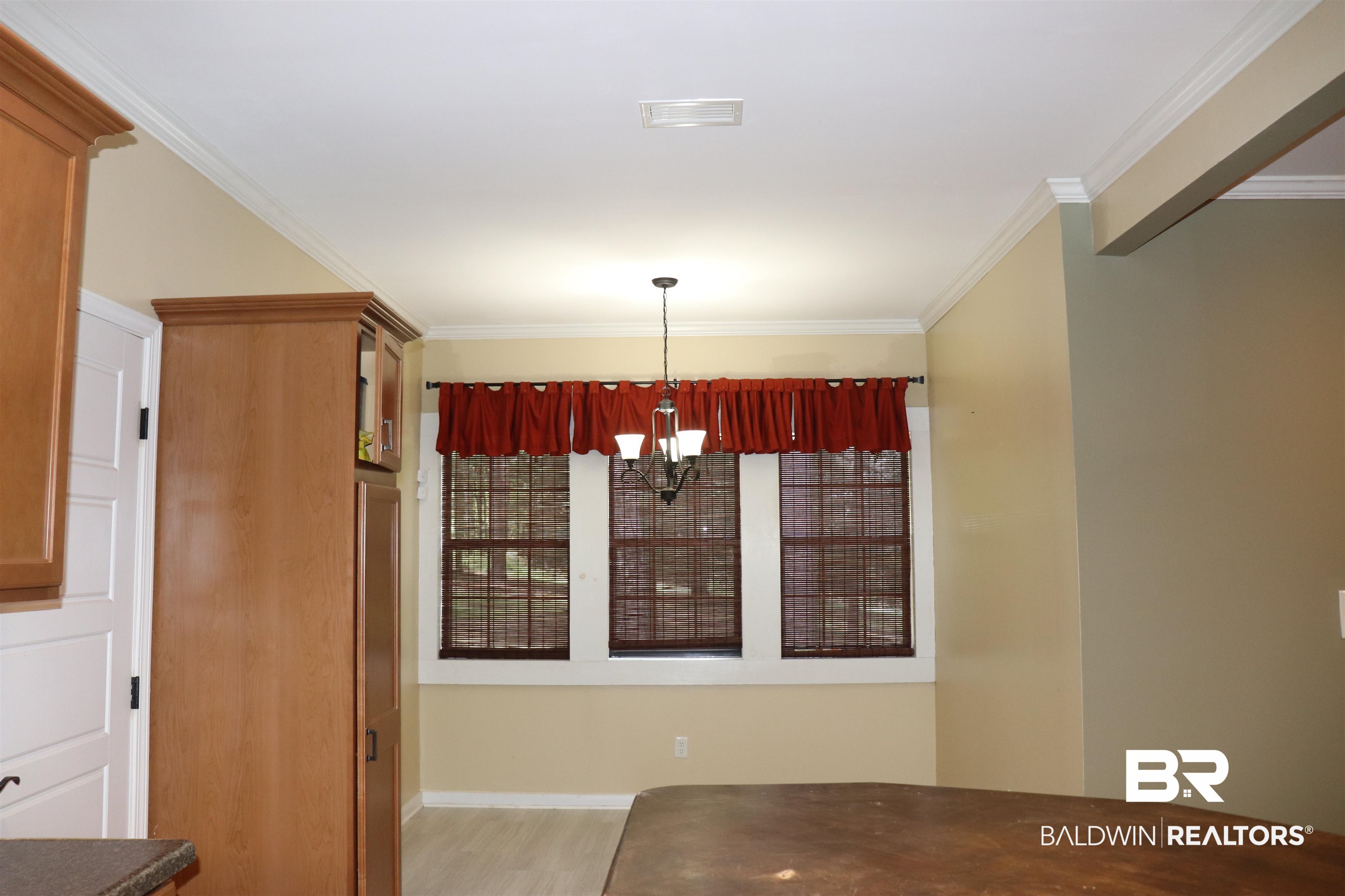 102 Brown Road Evergreen, AL 36401 - Photo 9 of 26 Unfurnished dining area featuring crown molding, a chandelier, and light wood finished floors
