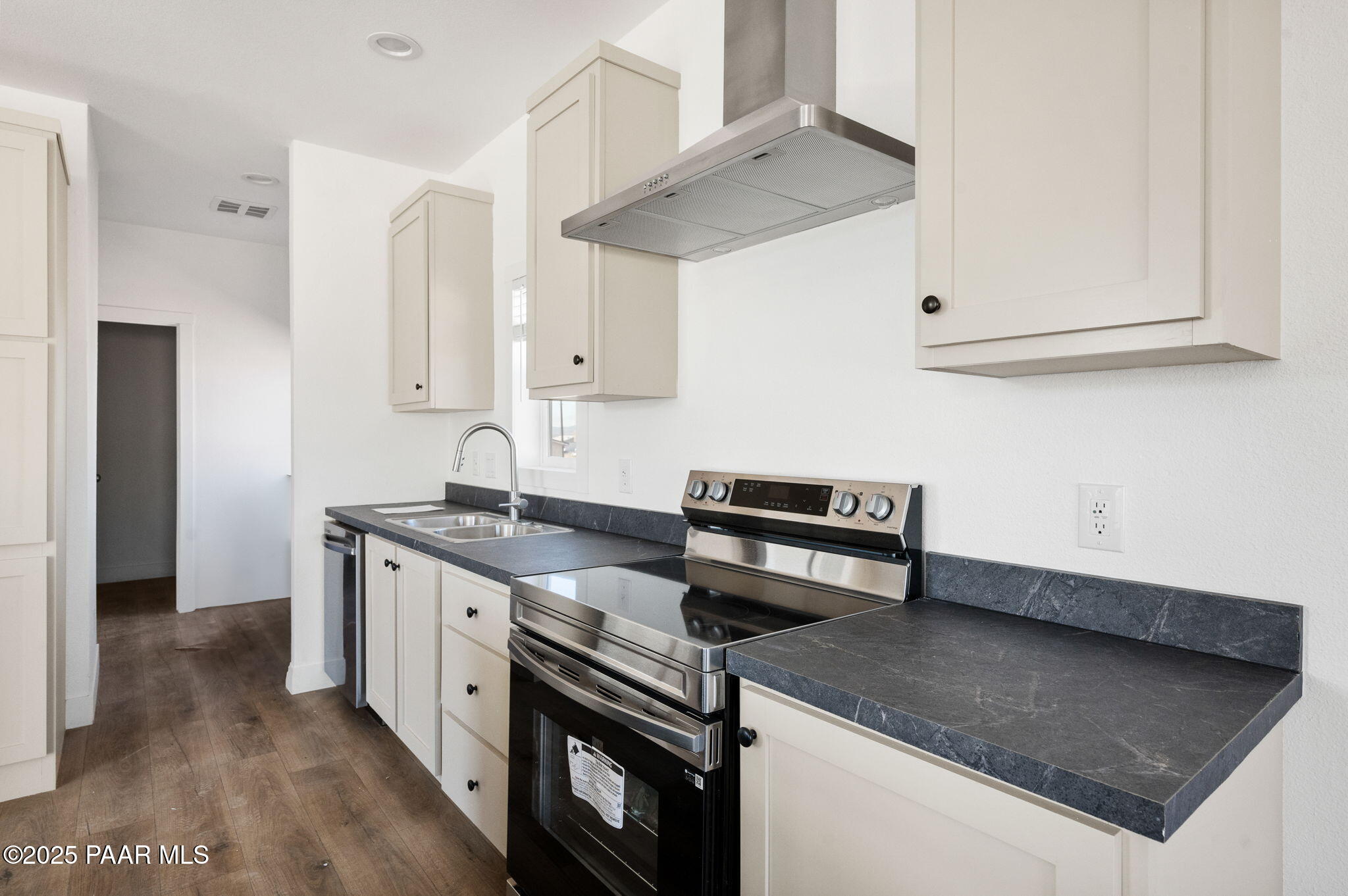 39 East Abra Road Paulden, AZ 86334 - Photo 6 of 23 a kitchen with stainless steel appliances granite countertop a sink stove and cabinets