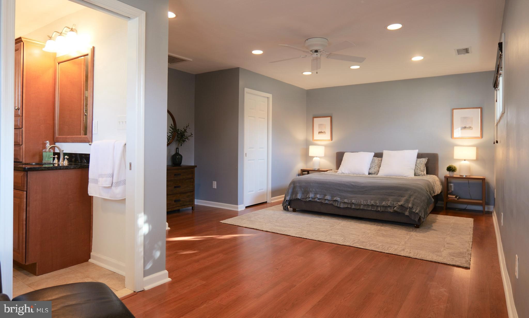 7323 Inzer Street Springfield, VA 22151 - Photo 14 of 25 a bedroom with a bed and a potted plant