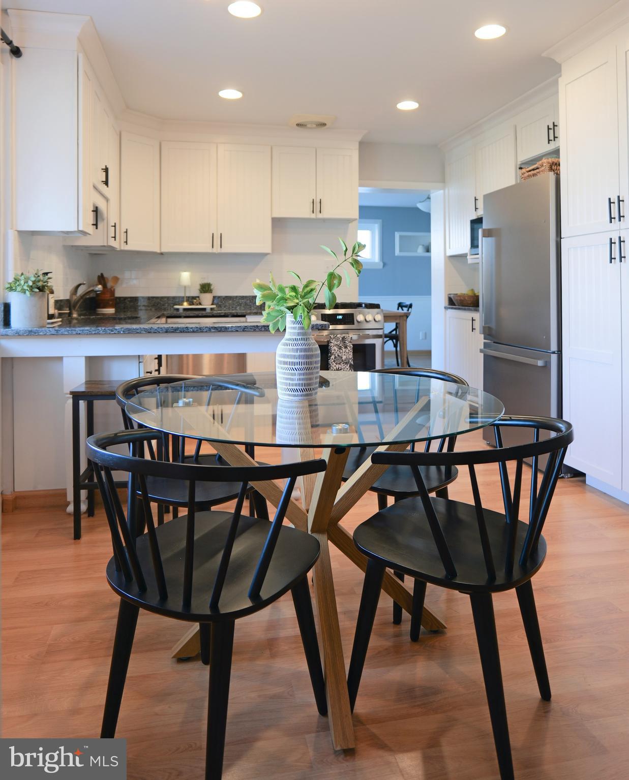 7323 Inzer Street Springfield, VA 22151 - Photo 5 of 25 a kitchen with stainless steel appliances granite countertop a dining table chairs refrigerator and sink
