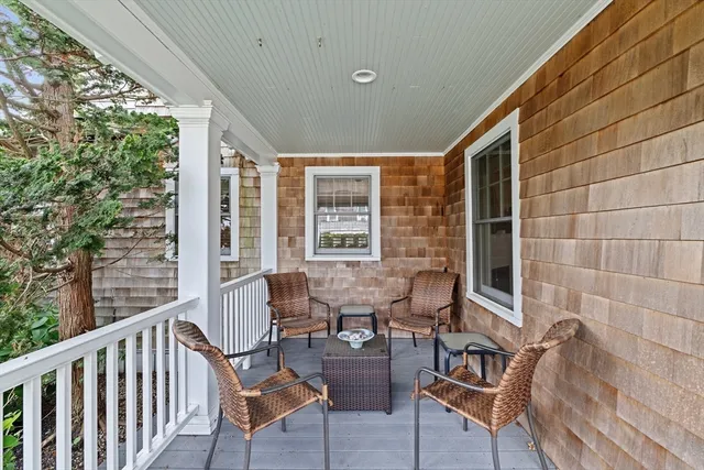 a view of a chairs and table in the balcony