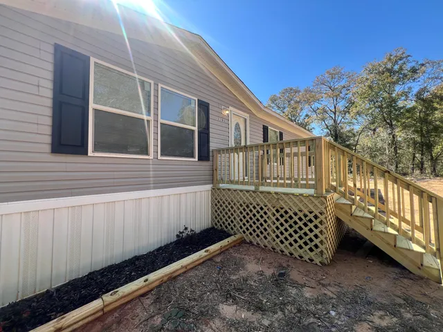 a front view of a house with a wooden fence