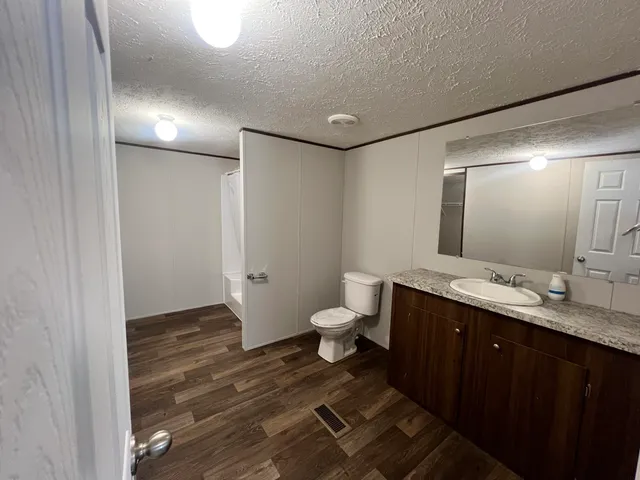 a view of a room with wooden floor