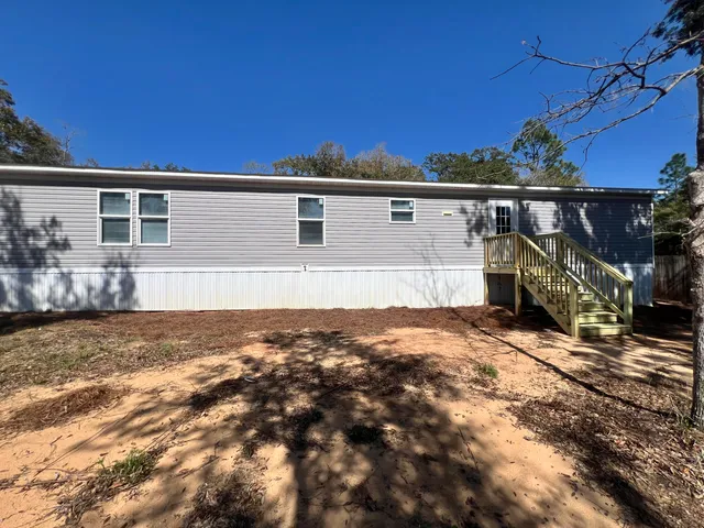 a view of a house with a backyard