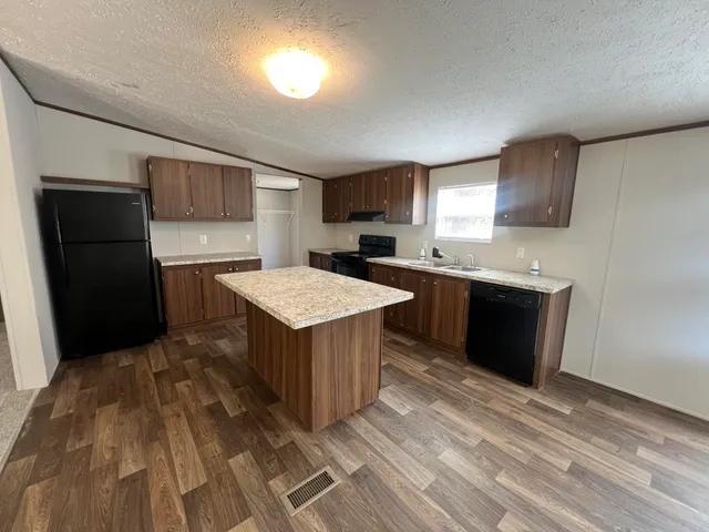 a kitchen with a sink a counter top space and appliances