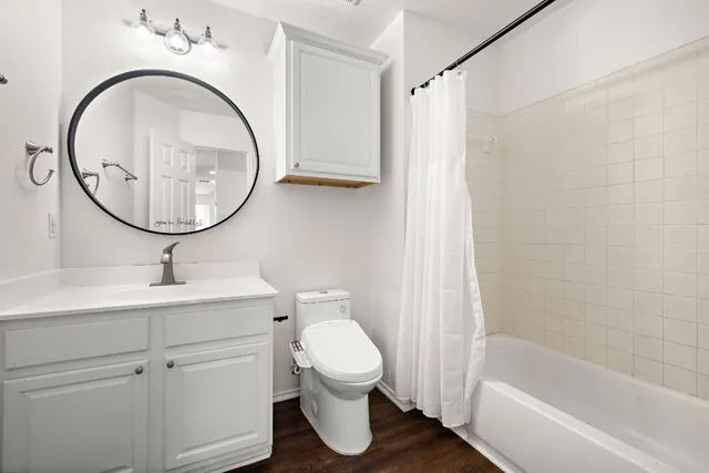 a bathroom with a sink a toilet and a mirror