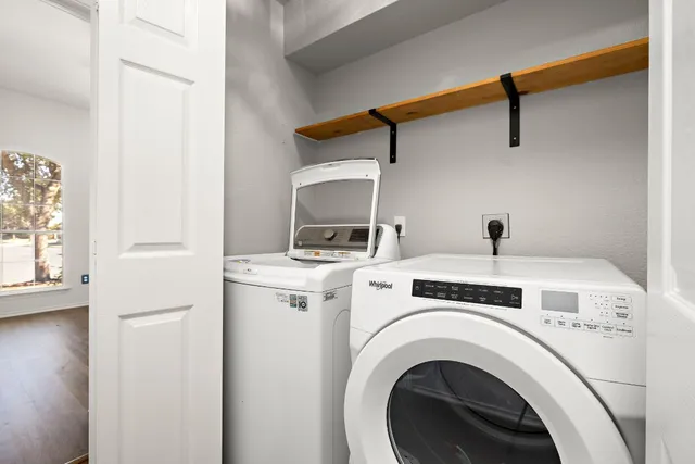 a view of washer and dryer with kitchen in the background
