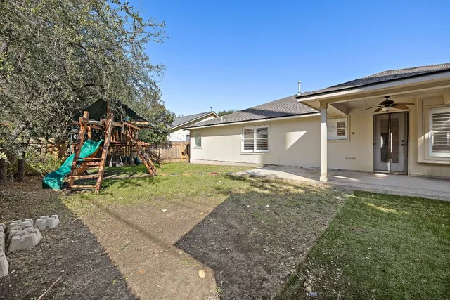 a view of a house with a backyard