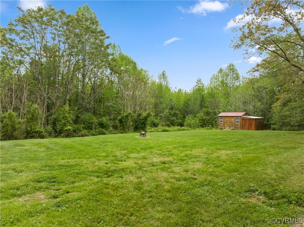 4660 Marks Lane Goochland, VA 23063 - Photo 30 of 39 a view of a grassy field with trees in the background