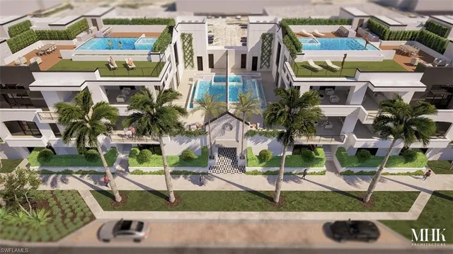 an aerial view of a residential building with parking