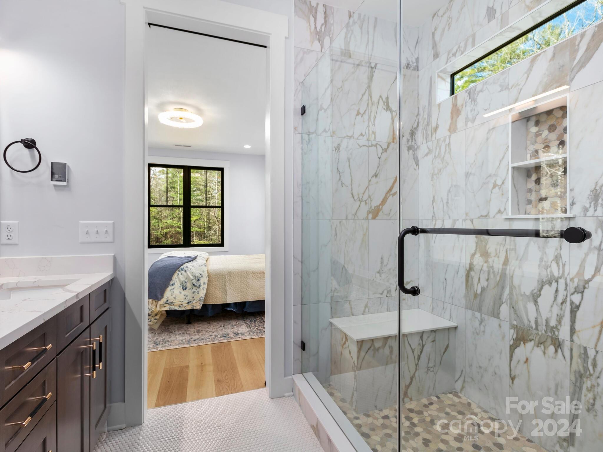 70 Reta Road Fairview, NC 28730 - Photo 12 of 22 a en suite spacious bathroom with a tub shower and window