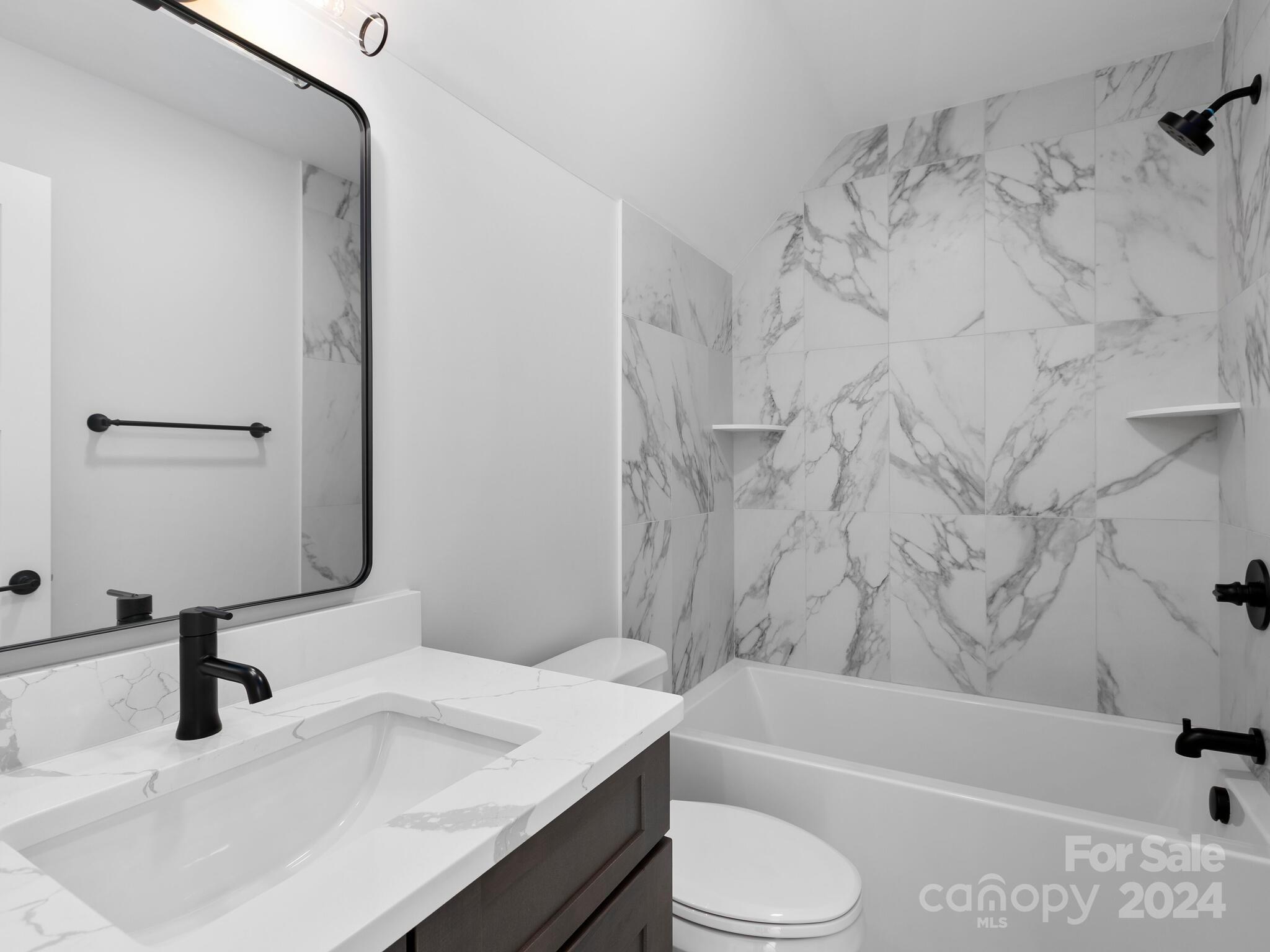 70 Reta Road Fairview, NC 28730 - Photo 16 of 22 a bathroom with a sink toilet vanity and bathtub