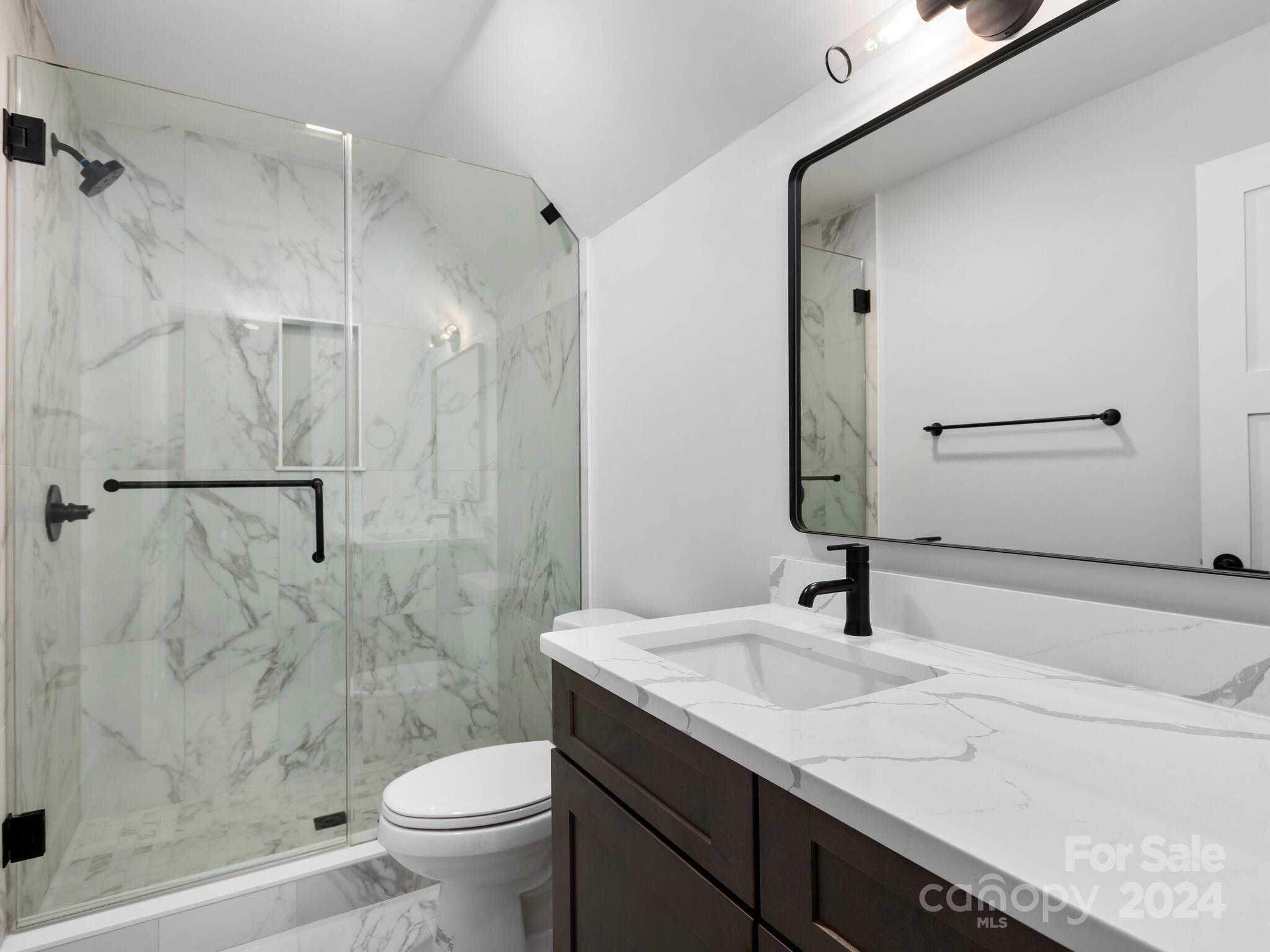 70 Reta Road Fairview, NC 28730 - Photo 18 of 22 a bathroom with a sink toilet and shower